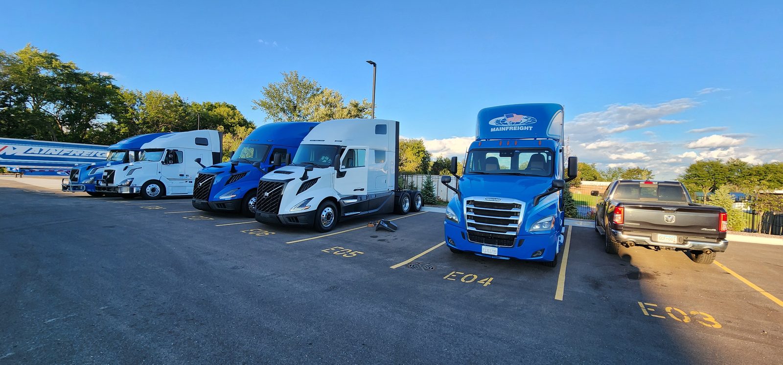 Long-haul freightliner and Volvo tractors at a truckstop